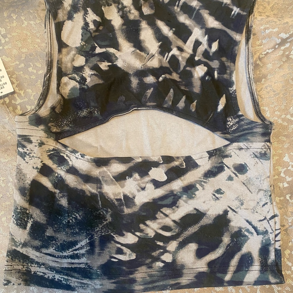 Navy blue tie dye, cut out in the back t-shirt with a neon green butterfly
